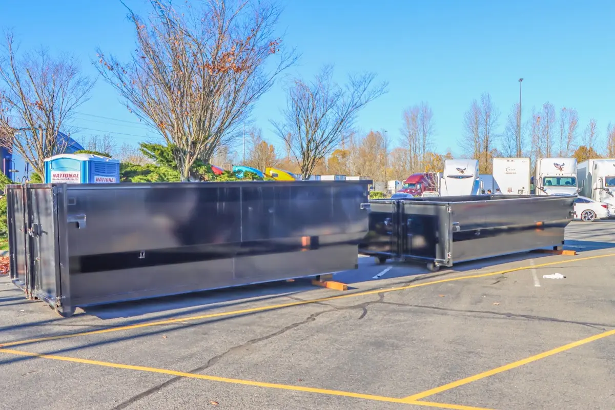 Professional dumpster rental service with roll-off container on residential driveway in Rossford